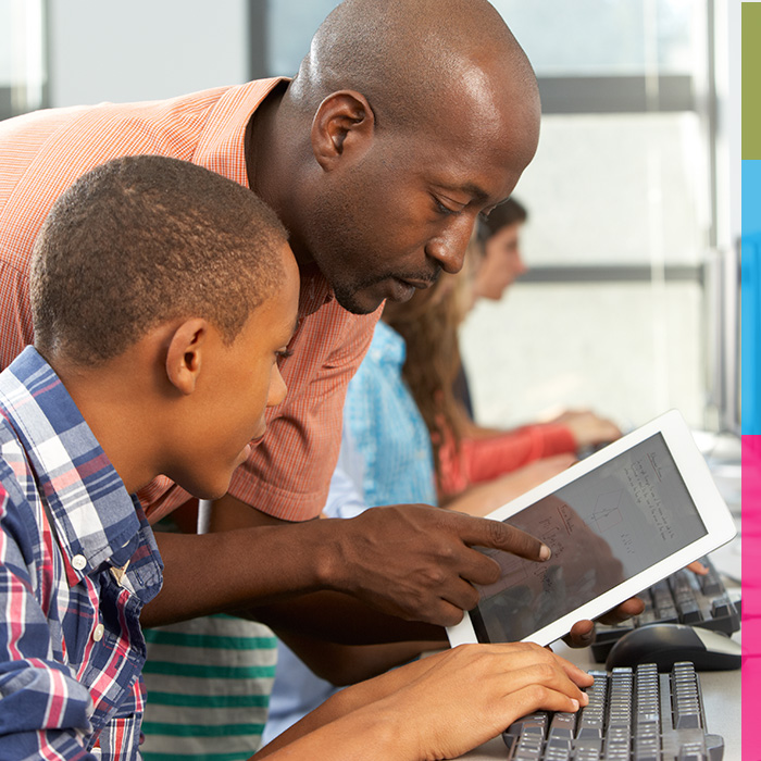 photo of male teacher helping student